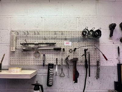 a picture of a workbench with tools hanging on it