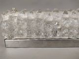 an image of a glass sculpture on a metal stand