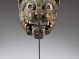 a close up of a sculpture of a head on a stand