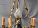 an image of a black and gold chandelier with five candles