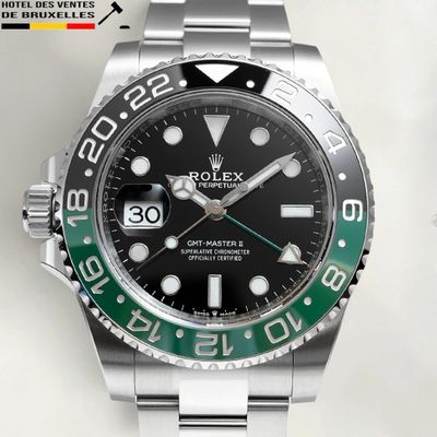rolex watch with a black dial and green bezel