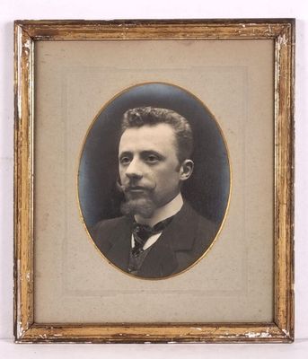 portrait of a man in a suit and tie in a gold frame