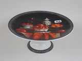 a plate with a picture of tomatoes on it on a stand