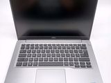 an open laptop computer sitting on top of a white table