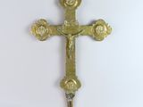 brass cross on a white background
