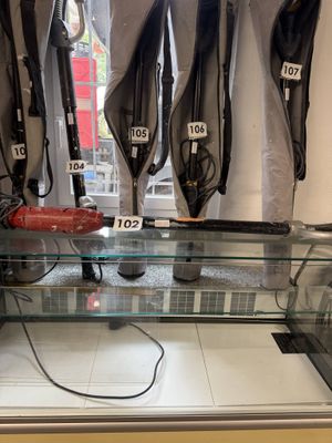 a glass display case in a store with umbrellas on the wall
