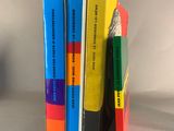 four books stacked on top of each other on a table