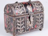 silver and black box with floral design on it on a white background