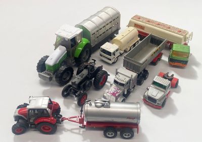 many toy trucks and trucks that are on the table