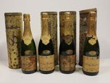 six bottles of champagne are lined up in a row