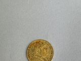 an image of a gold coin with a picture of a man on it