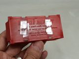 a small red box that has a piece of tape on it