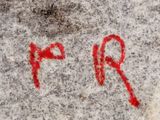 a red spray painted on the side of a building