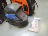 a welding helmet and other equipment on the floor