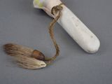 a toothbrush and a brush on a gray surface
