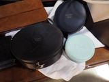 three bags and a wallet on a table