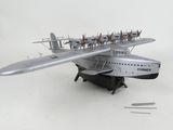 a silver model of a plane with a bunch of people on it