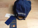 a baseball cap and a passport on a wooden table