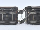 two pieces of black electrical equipment on a white surface
