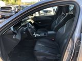 the interior of a car with the door open and the driver ' s seat down