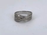 a close up of a silver ring on a white surface