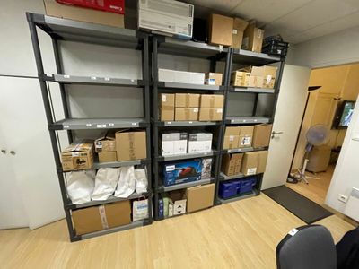 a room with a lot of boxes on the shelves