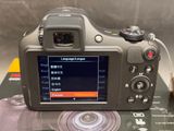 a digital camera that is sitting on top of a book