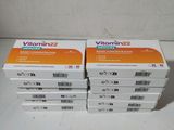 three boxes of vitamin 2 tablets on a white surface