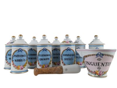 four blue and white canisters with flowers on them next to a wooden spoon