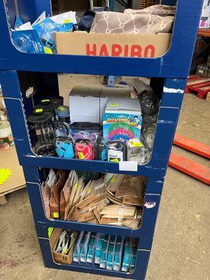 un chariot bleu chargé de divers objets dans un entrepôt