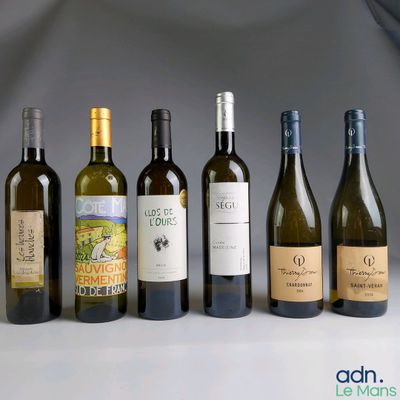 several bottles of wine are lined up in a row on a table