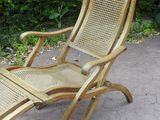 a wooden chair that is sitting on the pavement