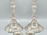 pair of silver candlesticks with ornate design