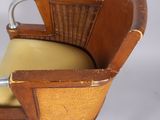 a chair with a wicker back and a yellow seat