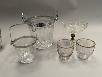 a silver and glass ice bucket and glasses on a table