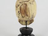 an image of a wooden head on a black stand