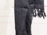 black scarf on a mannequin stand in a white room