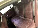 the back seats of a car with a purple seat cover
