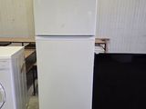 two refrigerators and a washing machine in a room
