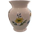 a white vase with a floral design on it