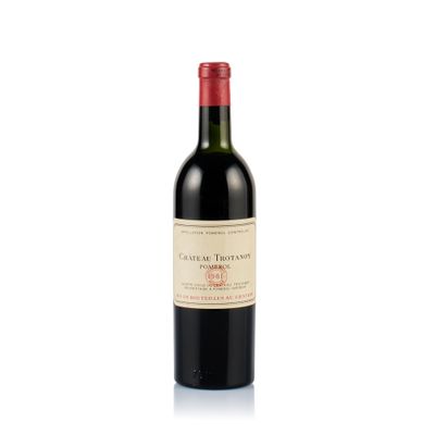 a bottle of red wine sitting on a white surface