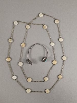 collier et écouteurs suspendus à une chaîne en argent ornée de cercles blancs