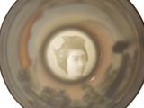 a glass with a picture of a woman inside of it