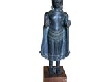 an image of a statue of a person standing on a block