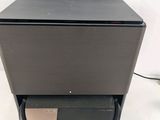 a close up of a black speaker on a stand on a white surface