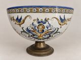 a blue and white bowl sitting on a stand