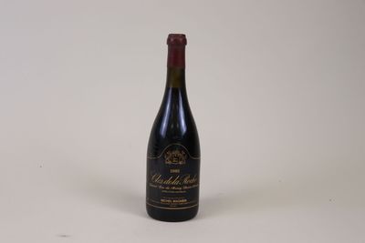 an old bottle of wine sitting on a table with a white background
