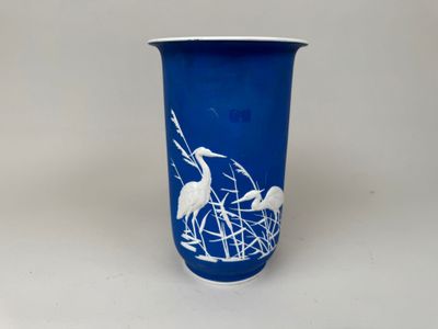 un vase bleu orné d'un motif blanc