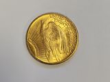 a close up of a gold coin on a white surface