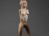 a wooden statue of a man with a hat on his head